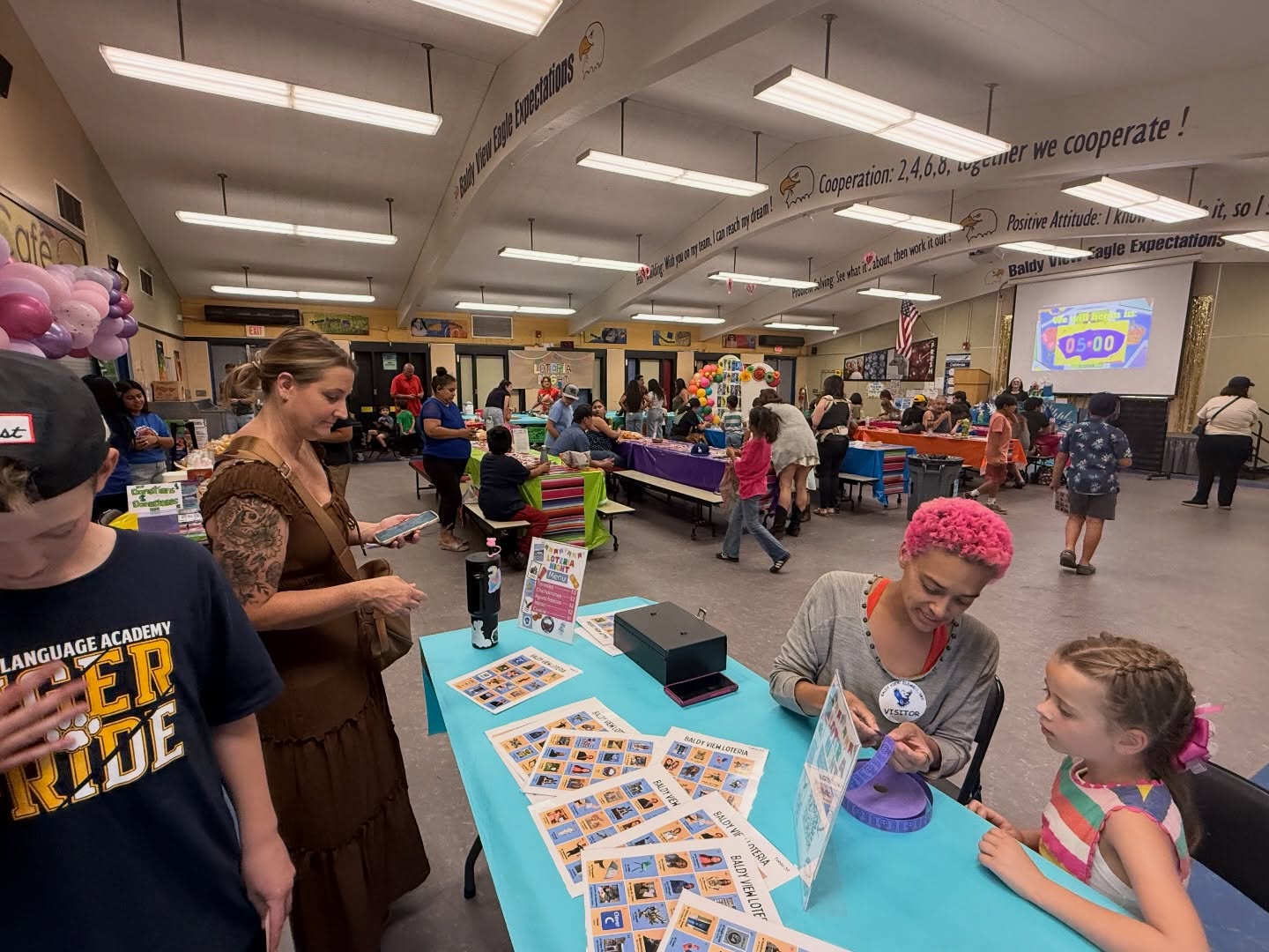 Baldy View families gathering at a colorful Lotería Night celebration